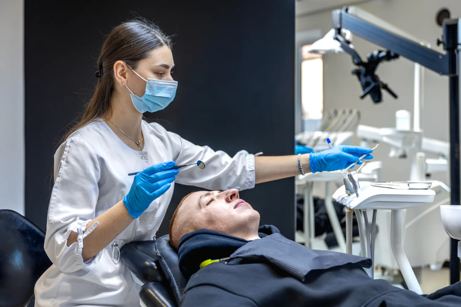 female-dentist-treats-patients-teeth-stomatologist-working-with-professional-equipment female-dentist-treats-patients-teeth-stomatologist-working-with-professional-equipment